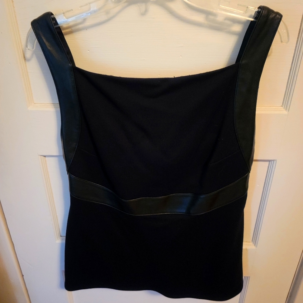 Black with fauxeather details and straps. Cute open back.  Size large